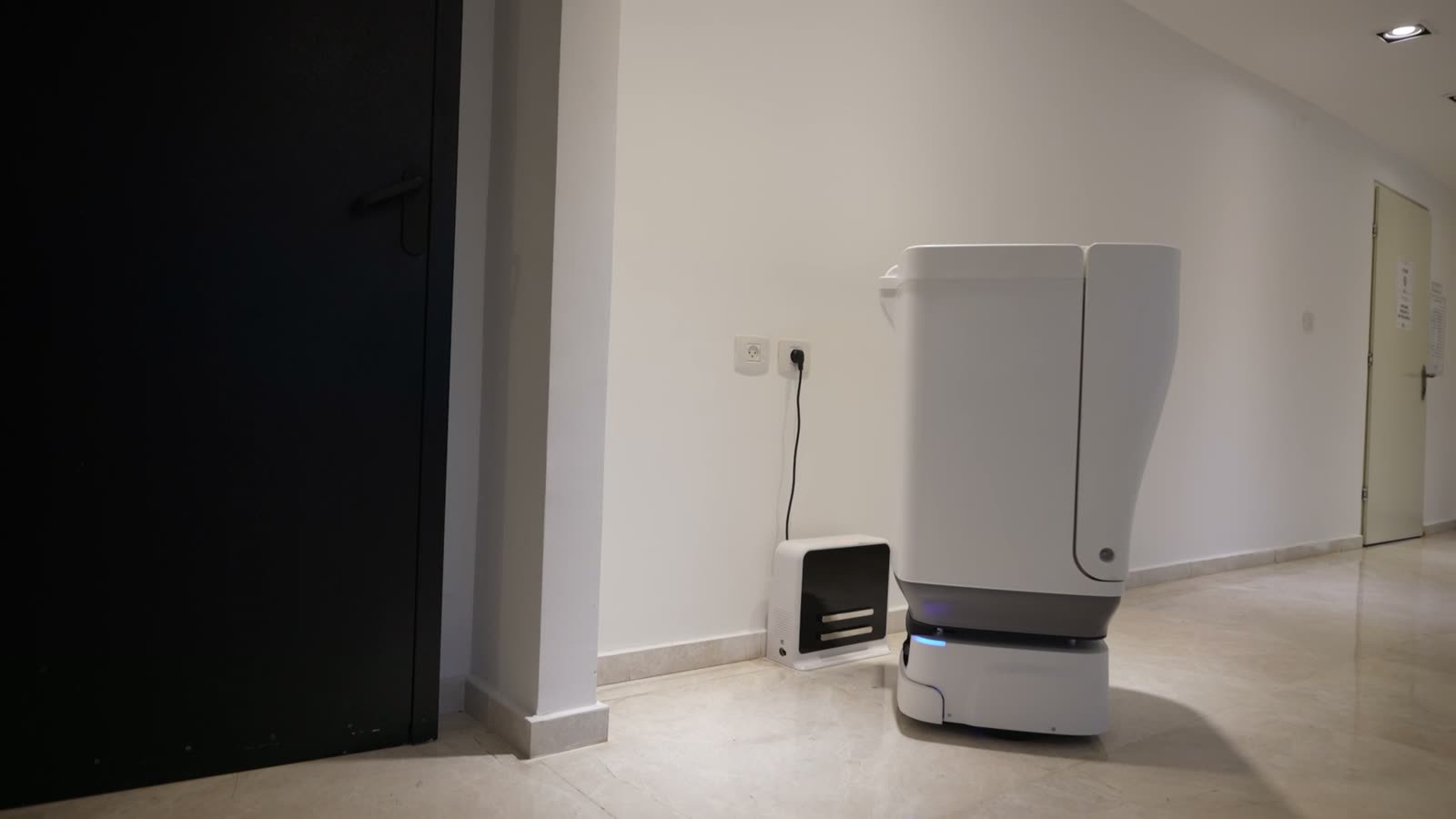 Skip at its home dock in a residential hallway