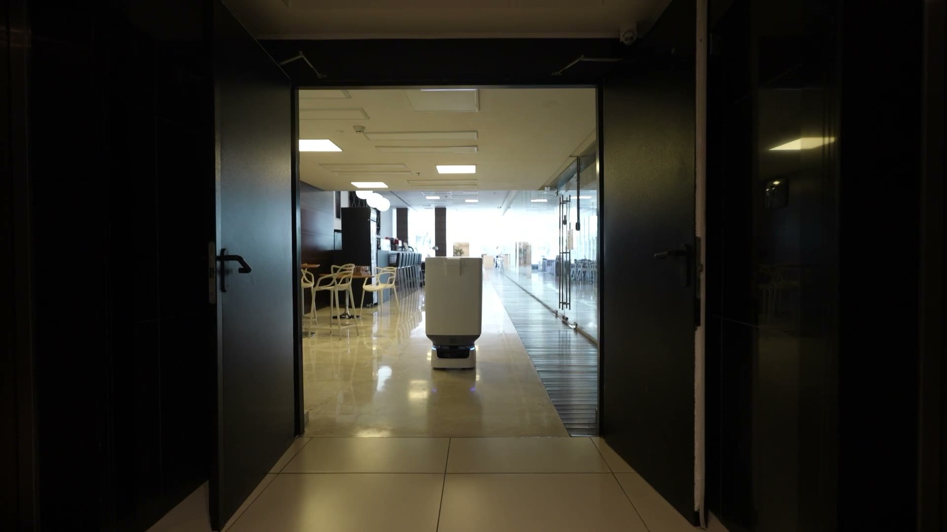 Skip, Ottero's trash-valet robot, gliding through a residential lounge